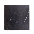 Black marble look alike porcelain tile with veins on a white background