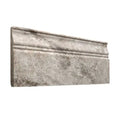 Forum Terra Grigio silver travertine baseboard trim, studio image showing a molded cool gray travertine profile with natural pores and subtle variation for clean wall-to-floor transitions.