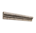Forum Terra Grigio silver travertine ogee chair rail liner, studio image showing a molded cool gray travertine profile with natural pores and subtle variation for decorative borders and wall transitions.