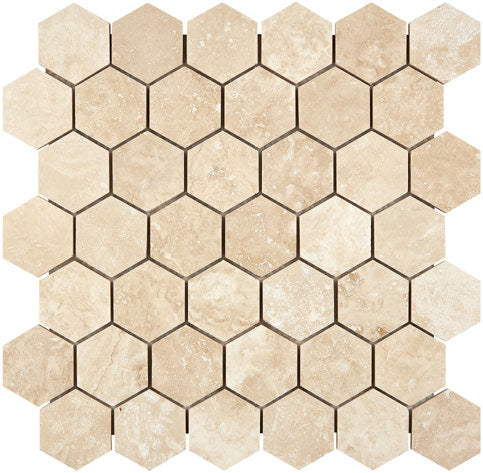 Forum Terra Ivory travertine 2-inch hexagon mosaic sheet honed, studio image showing warm ivory-beige tones with natural pores and quiet variation for shower floors and spa-style accents.