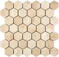 Forum Terra Ivory travertine 2-inch hexagon mosaic sheet tumbled, studio image showing warm ivory-beige tones with natural pores and quiet variation for shower floors and spa-style accents.
