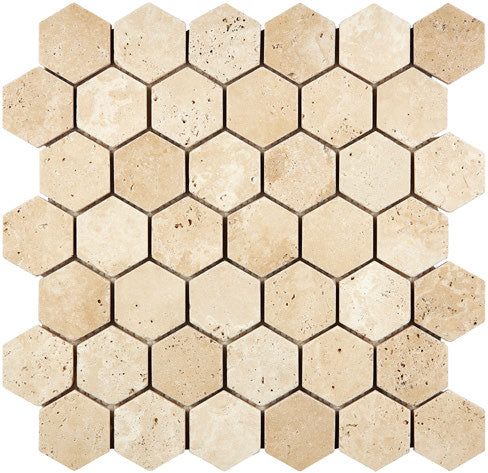 Forum Terra Ivory travertine 2-inch hexagon mosaic sheet tumbled, studio image showing warm ivory-beige tones with natural pores and quiet variation for shower floors and spa-style accents.