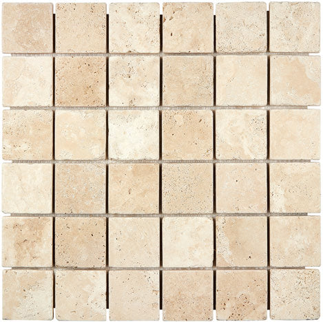 Forum Terra Ivory travertine 2x2 mosaic sheet tumbled, studio image showing warm ivory-beige tones with natural pores and quiet variation in a clean grid for shower floors and wet-area accents.
