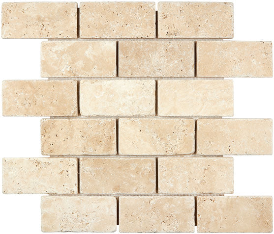 Forum Terra Ivory travertine 2x4 brick mosaic sheet tumbled, studio image showing warm ivory-beige tones with natural pores and quiet variation in a classic running-bond pattern for shower floors and accents.