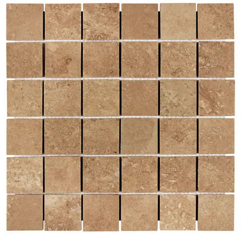 Forum Terra Umber travertine 2x2 mosaic sheet honed and filled, studio image showing rich warm brown tones with a smoother filled surface, subtle pore character, and natural variation in a clean grid for shower floors and wet-area accents.