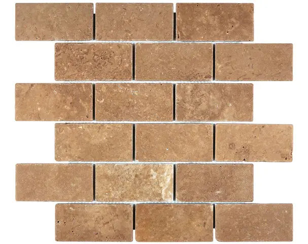 Forum Terra Umber travertine 2x4 brick mosaic sheet tumbled, studio image showing rich warm brown tones with natural pores and subtle variation in a classic running-bond pattern for shower floors and accents.