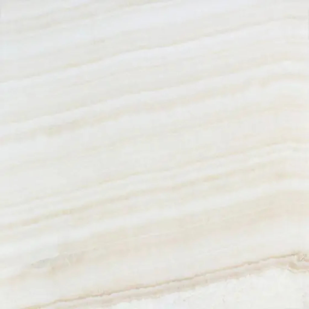 Opalus Vanilla onyx tile 18x18 cross-cut, studio image showing creamy ivory tones with soft cloud-like movement, natural translucency, and subtle tonal variation.