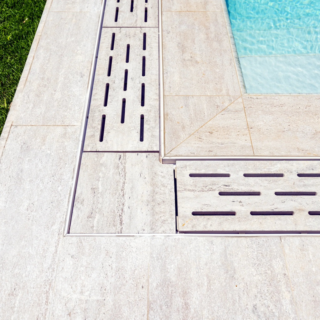 Relax porcelain flexible drain grate and corner detail installed beside pool coping