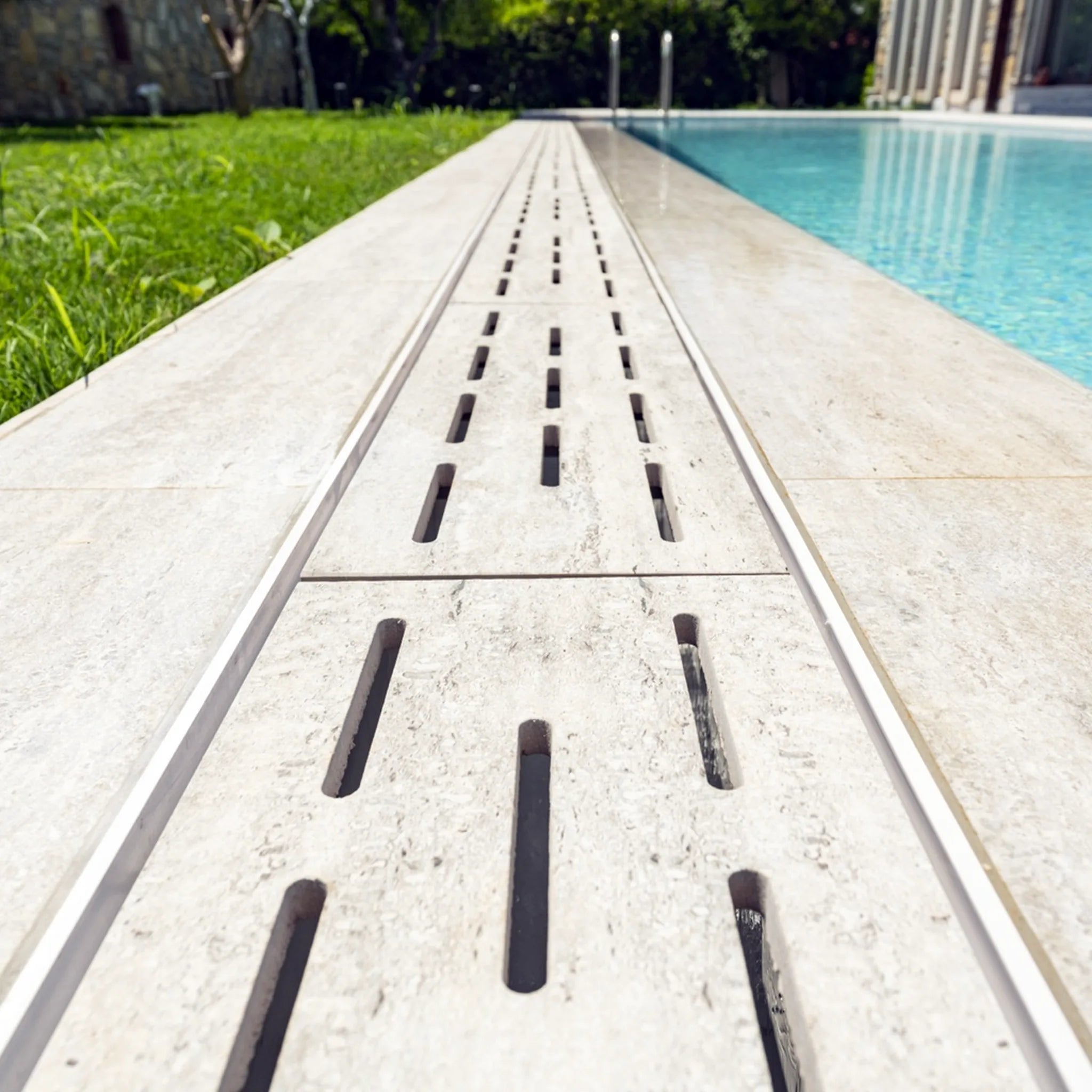Relax porcelain flexible drain grate installed as long linear run along poolside