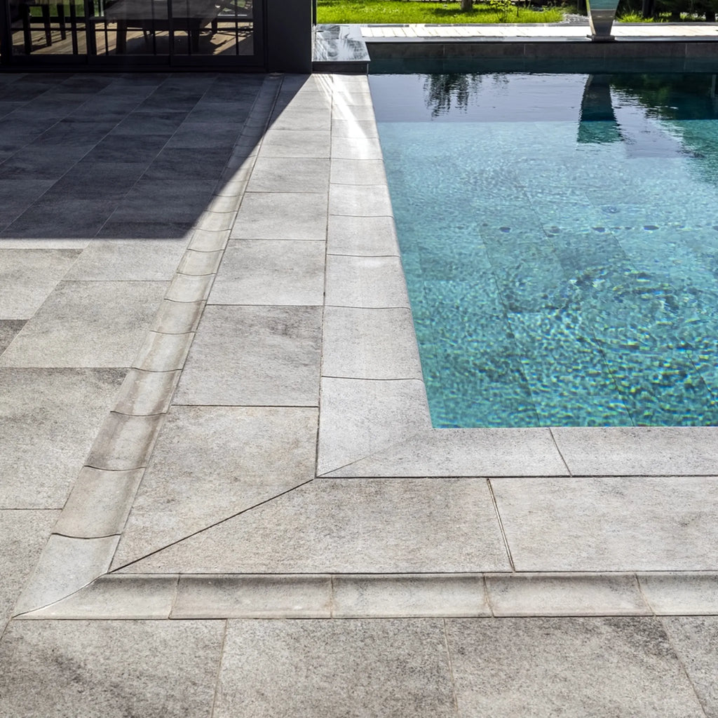 Installed pool coping detail with porcelain deck pavers and turquoise pool water, Relax Pool & Spa collection
