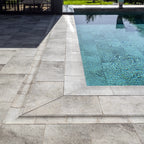 Installed pool coping detail with porcelain deck pavers and turquoise pool water, Relax Pool & Spa collection
