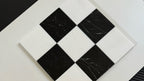 Black and white checkered tile with visible wear on a white background