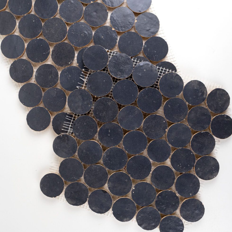 ArtePierre Zellige Atelier Circles glossy zellige mosaic sheets in Atlas Indigo (Navy), stacked studio image highlighting handmade surface depth, tonal variation, and subtle edge irregularity for backsplashes and shower walls.