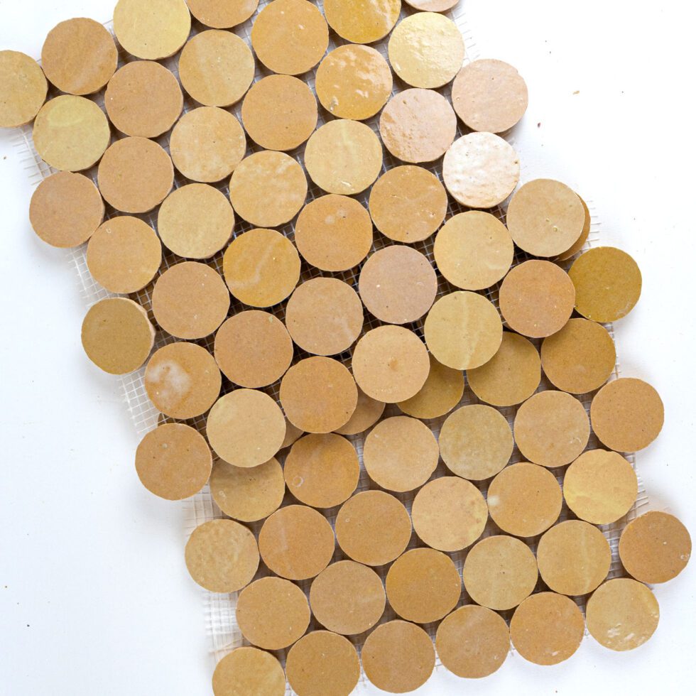 ArtePierre Zellige Atelier Circles glossy zellige mosaic sheets in Nomad Dune, stacked studio image highlighting handmade surface depth, tonal variation, and subtle edge irregularity for backsplashes and shower walls.