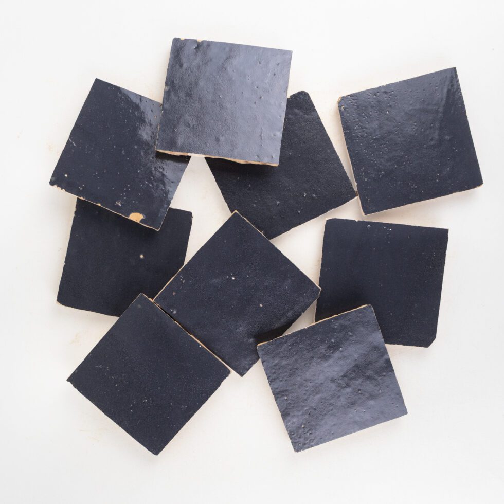 Loose Indigo Bazaar 4x4 glossy zellige tiles showing handmade surface texture and natural shade variation.