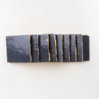 Side profile of Indigo Bazaar glossy zellige 4x4 tiles showing hand-cut edges and thickness variation.