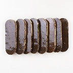 Close-up of Noir Cacao long oval zellige showing glossy glaze depth and handmade edges.