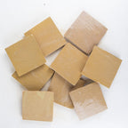 Nomad Veil zellige 4x4 tile, glossy sand-beige, loose sample tiles showing glaze movement