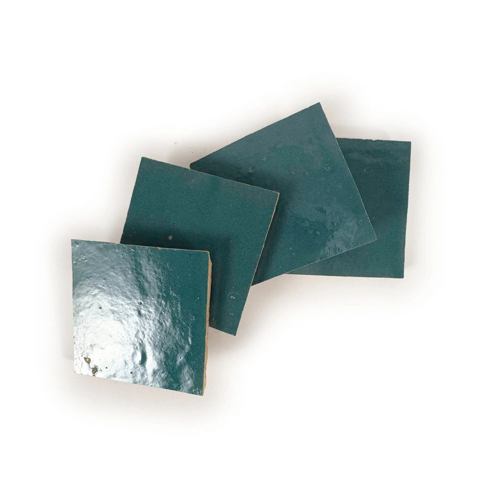 Stacked Blue Medina 4x4 glossy zellige tiles showing hand-cut edges and natural thickness variation.