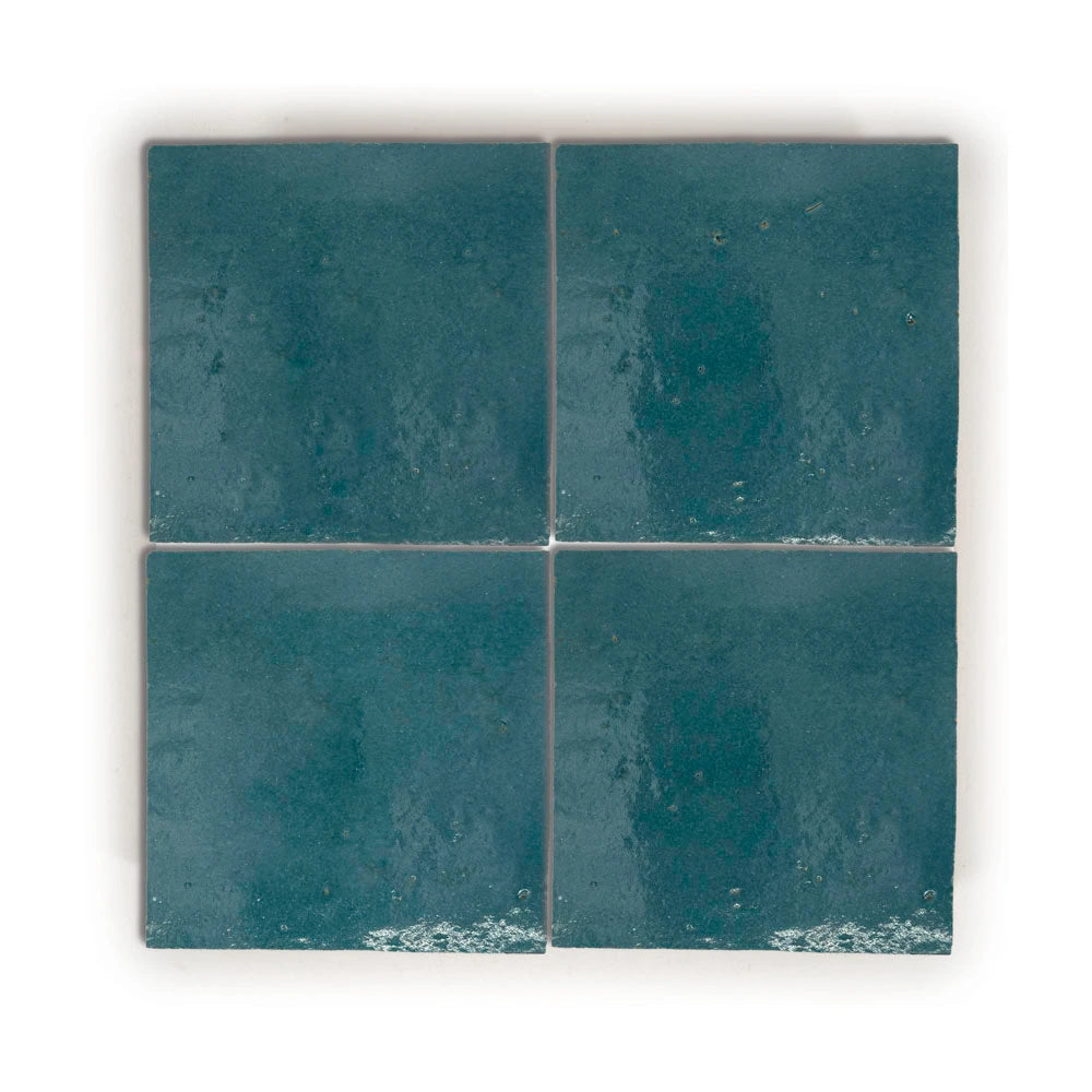 Blue Medina zellige tile 4x4 glossy, deep saturated blue handmade terracotta with natural glaze variation.