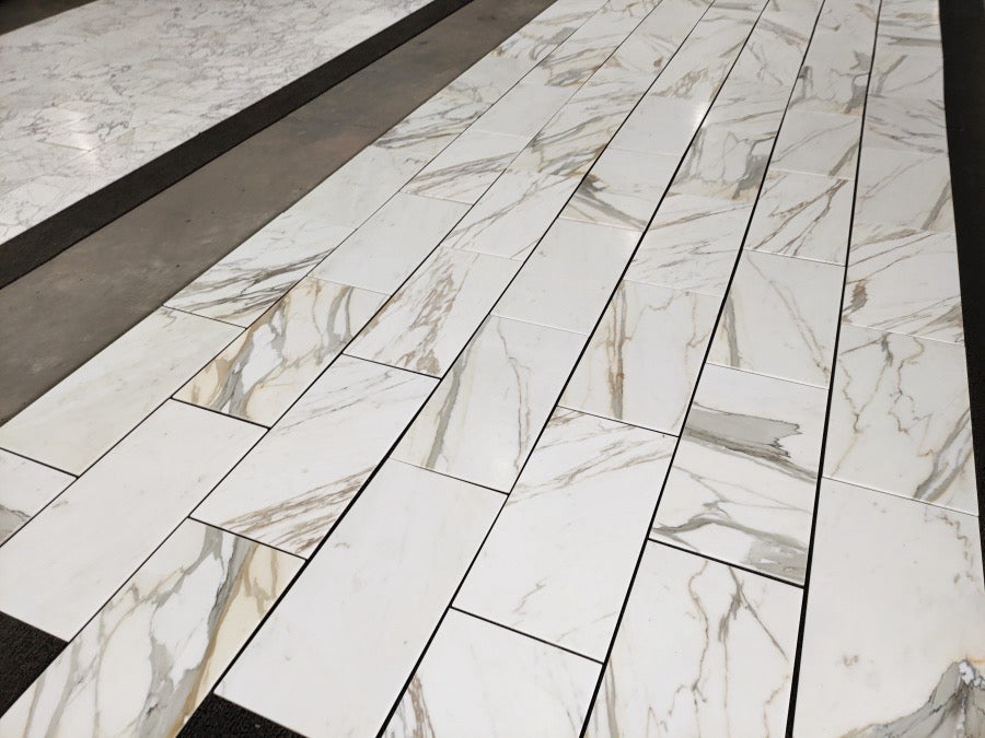 Aria Calacatta Gold Marble-patterned tiles on a floor