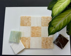 Checkered tile pattern with decorative stones on a white surface