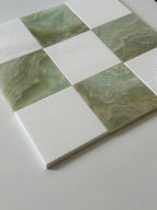 Green and white checkered pattern on a flat surface