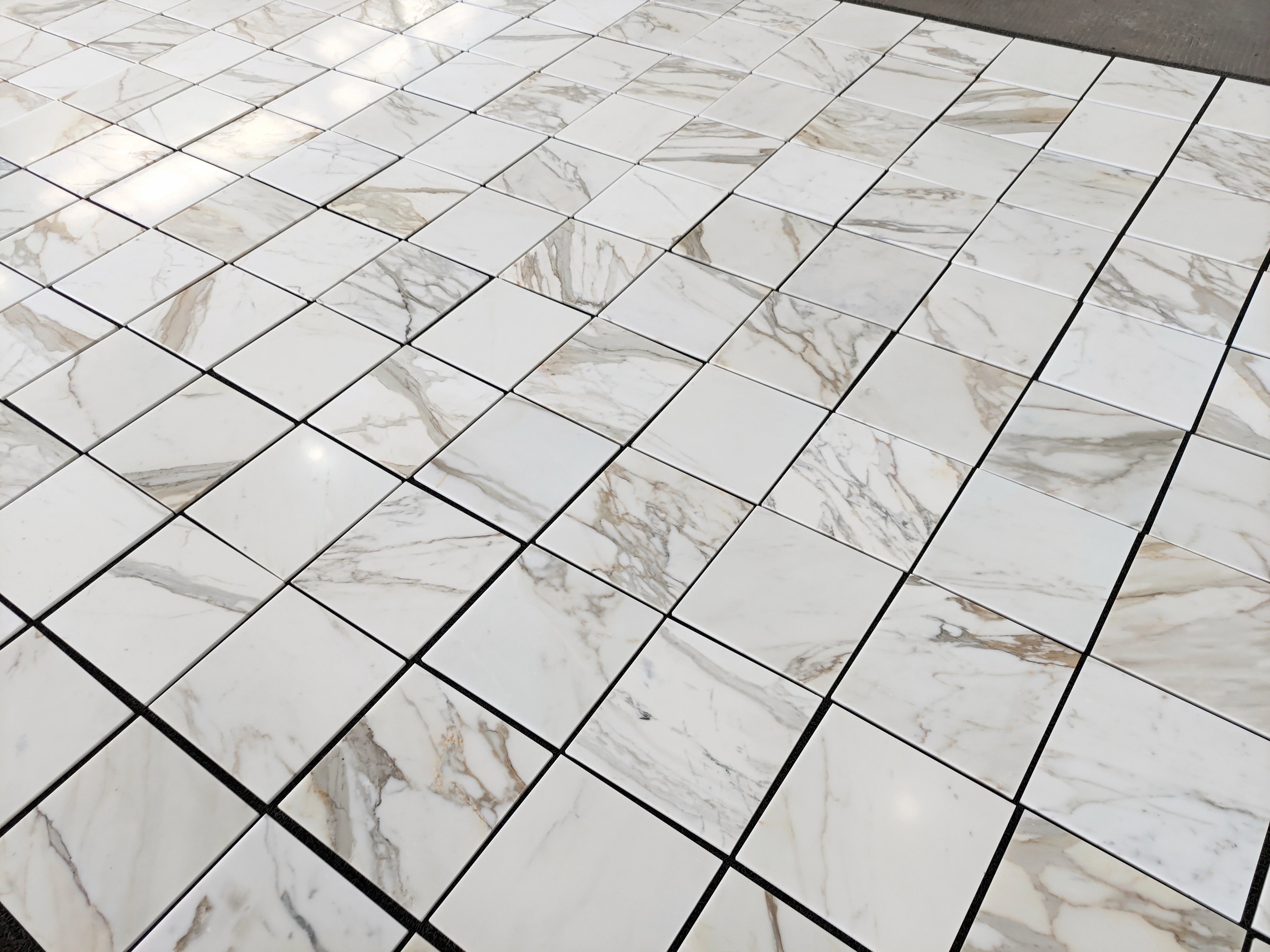 calacatta gold 12x12 marble tiles dry-lay for inspection and designer's final project approval 